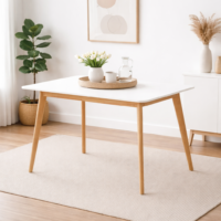 Table design scandinave avec plateau blanc et pieds en bois naturel intégrée dans un décor minimaliste lumineux, sans chaises, idéale pour intérieur moderne.