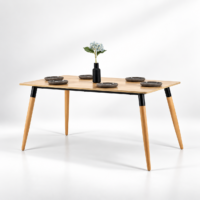 Table à manger scandinave moderne avec plateau en bois clair et pieds en bois naturel et métal noir, intégrée dans un décor intérieur simple et lumineux.