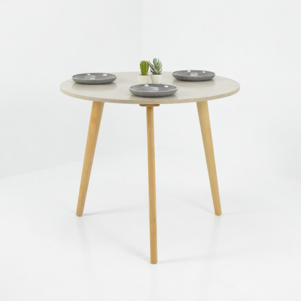 Cette table ronde au design scandinave se distingue par son plateau beige élégant et ses pieds en bois naturel légèrement inclinés. Intégrée dans un décor minimaliste et lumineux, elle apporte une touche de modernité et de chaleur à votre espace de vie. Parfaite pour une salle à manger contemporaine ou un coin repas raffiné, cette table combine fonctionnalité, esthétique et durabilité, tout en s’adaptant facilement à différents styles d’intérieur.