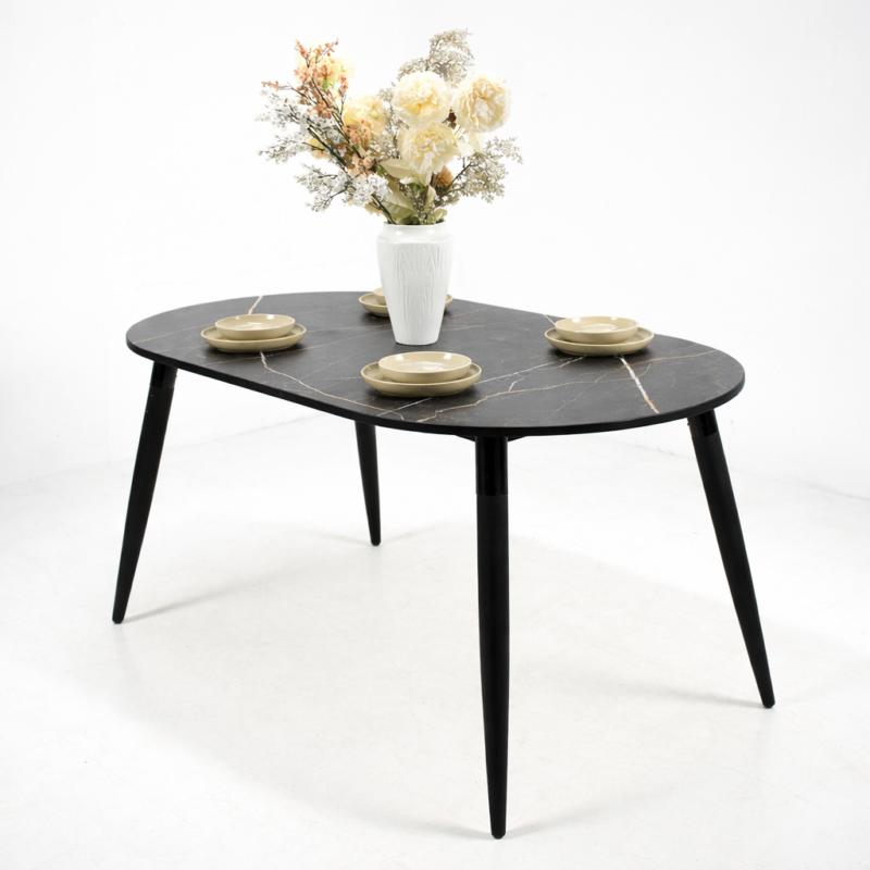 Table à manger ovale moderne avec plateau effet marbre noir veiné et pieds noirs en bois, présentée sur fond blanc épuré.