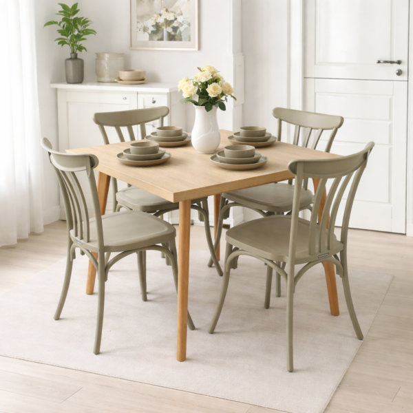 Table à manger carrée en bois clair avec quatre chaises vert sauge, intégrée dans une salle à manger simple, lumineuse et élégante