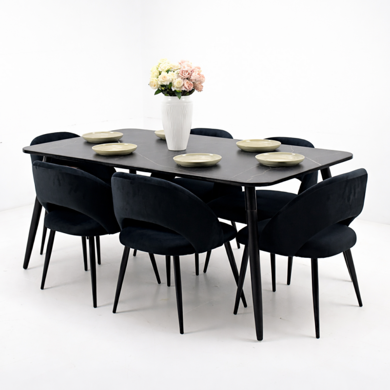 Salle à manger moderne composée d’une table rectangulaire noire et de six chaises noires au design contemporain, intégrée dans un décor sobre et élégant.