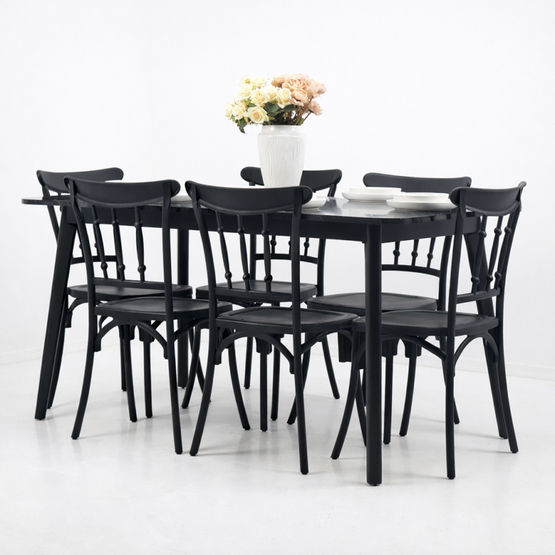 Salle à manger contemporaine avec table rectangulaire noire effet marbre et six chaises noires, décor minimaliste avec vase de fleurs sur la table.